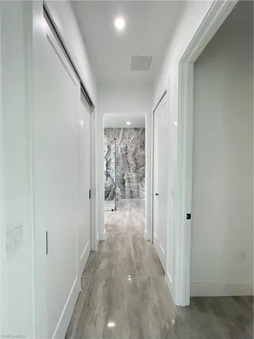 Corridor featuring wood-type flooring