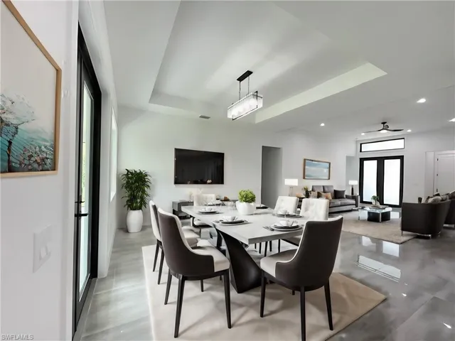 Dining space with ceiling fan and a tray ceiling
