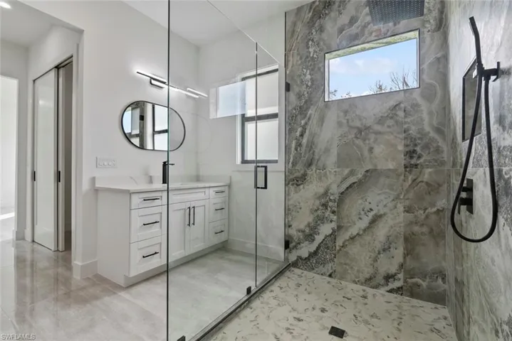 Bathroom with vanity and an enclosed shower