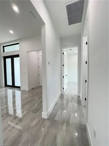 Corridor featuring french doors