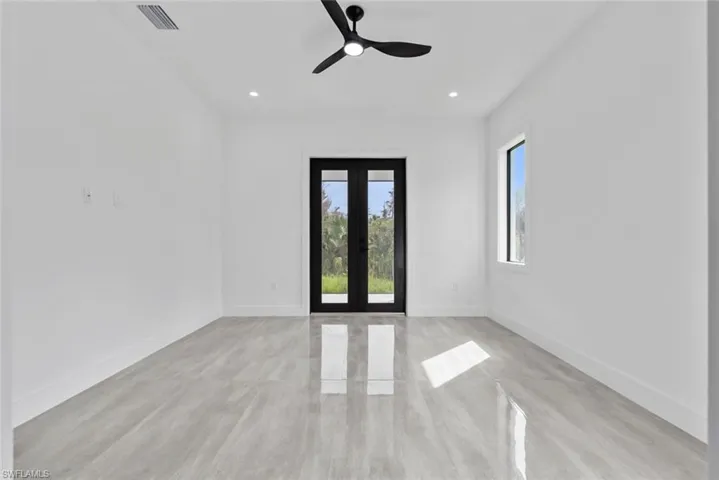 Spare room featuring light hardwood / wood-style flooring, french doors, and ceiling fan
