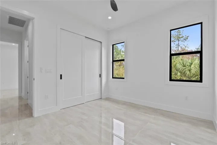 Unfurnished bedroom with a closet and ceiling fan