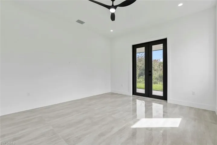 Spare room with french doors and ceiling fan