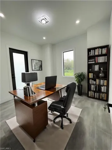 Office space with light hardwood / wood-style flooring