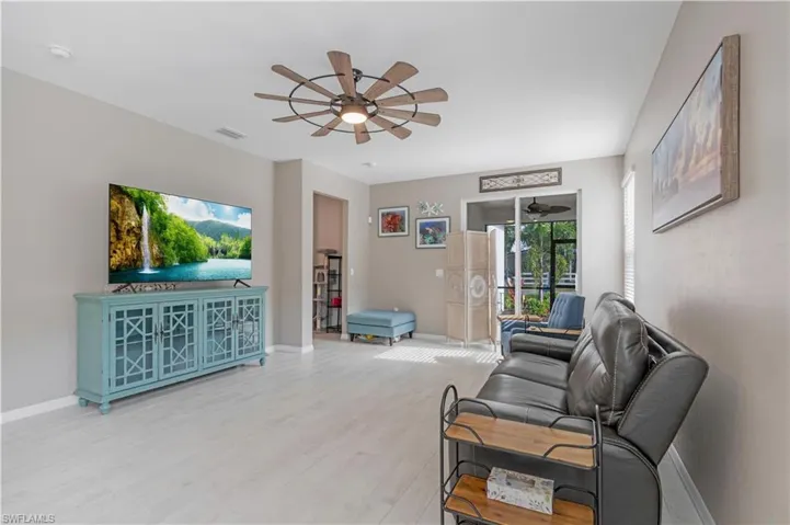 Living room featuring light hardwood / wood-style floors and ceiling fan
