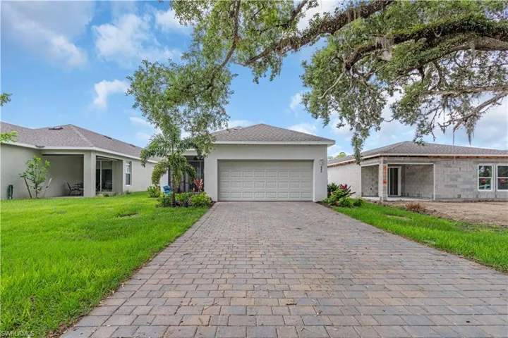 Ranch-style house with a garage and a front yard