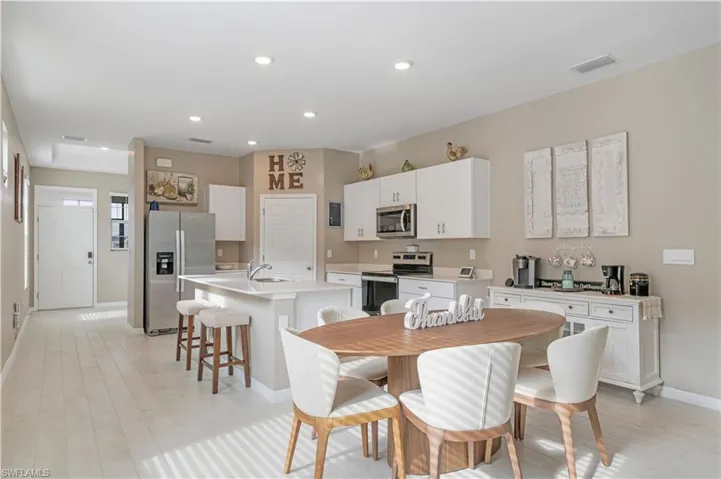 Dining space featuring sink and light hardwood / wood-style floors