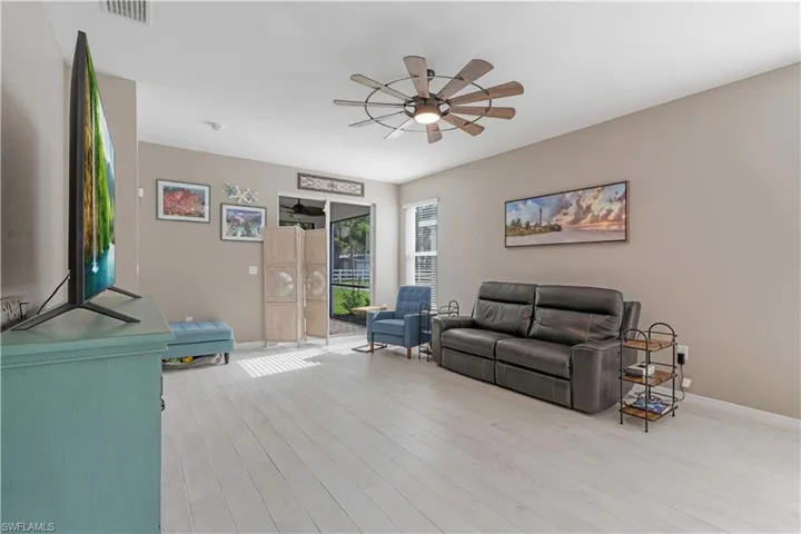 Living room featuring ceiling fan and light wood-type flooring