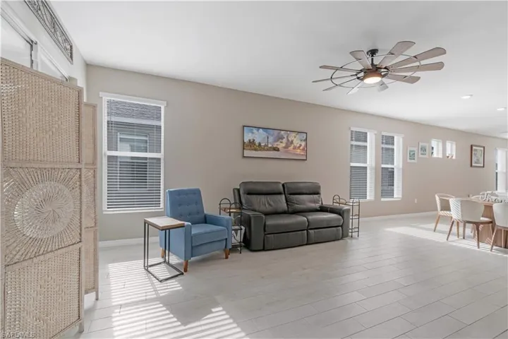 Living room with light hardwood / wood-style floors and ceiling fan