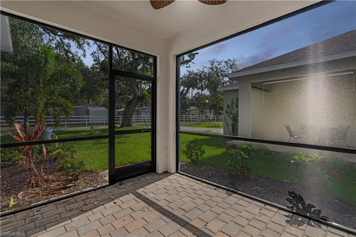 Unfurnished sunroom with ceiling fan