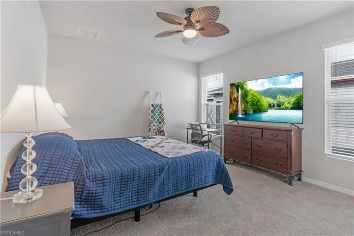 Bedroom featuring carpet and ceiling fan