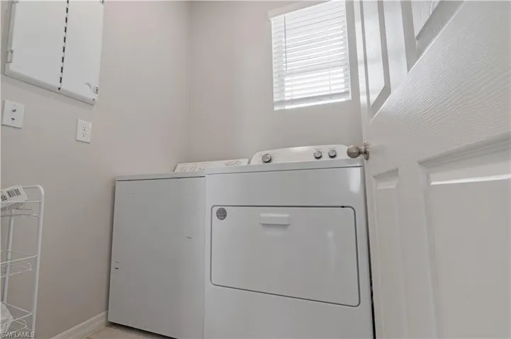 Laundry room with washer and dryer and cabinets