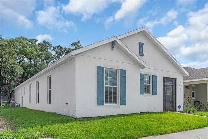 View of front of home featuring a front yard and central AC unit