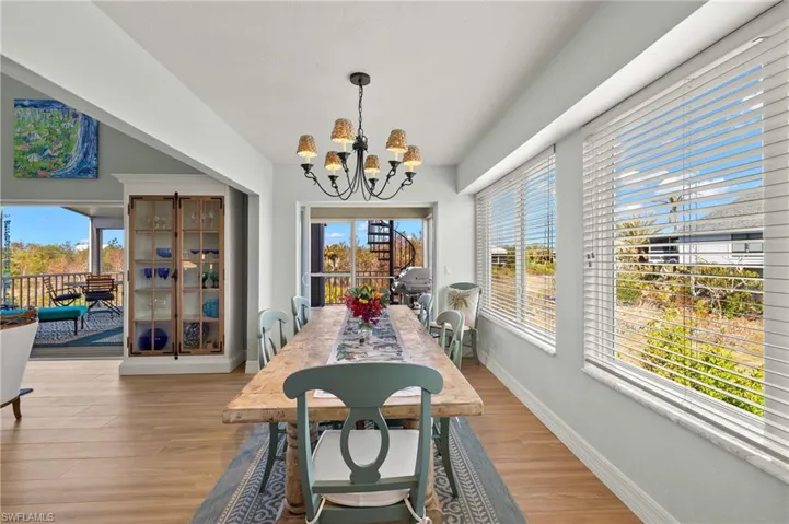 Dining room featuring light wood-type flooring and a chandelier