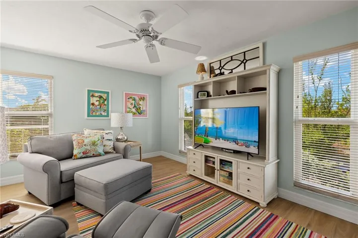 Living area featuring light wood-style floors and a ceiling fan