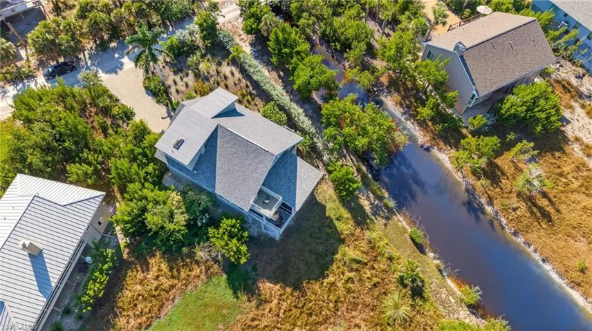 Aerial view of property and surrounding area featuring a large body of water