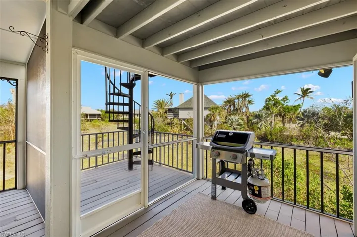 Wooden terrace featuring a grill