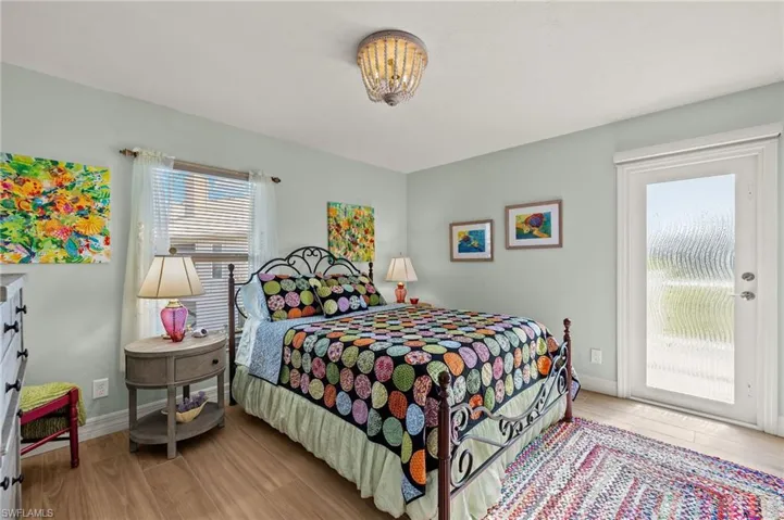Bedroom with light wood-type flooring and access to outside