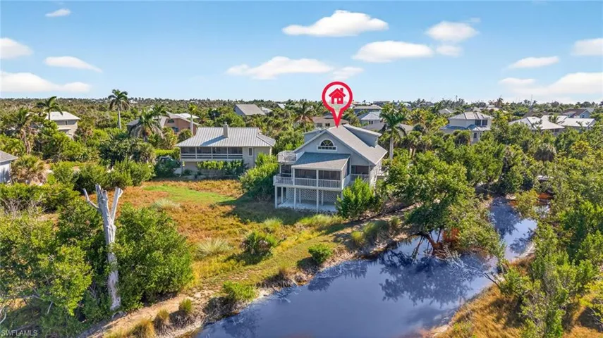 Aerial view of residential area featuring a large body of water