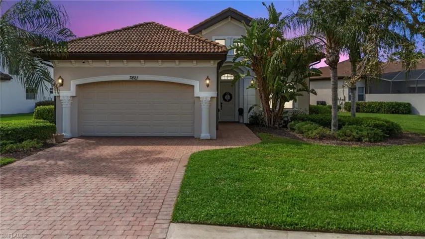 Mediterranean / spanish-style home with decorative driveway, an attached garage, stucco siding, and a front lawn
