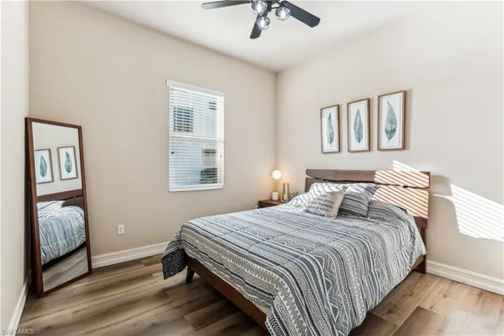 Bedroom featuring wood finished floors and a ceiling fan