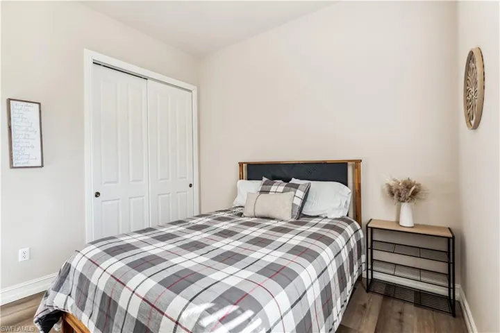 Bedroom with wood finished floors and a closet