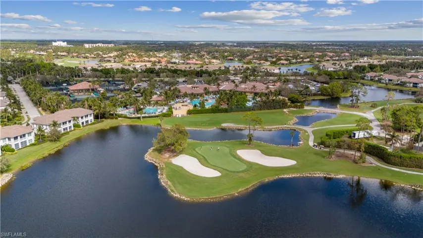 Aerial overview of property's location with a local golf course, a nearby body of water, and nearby suburban area