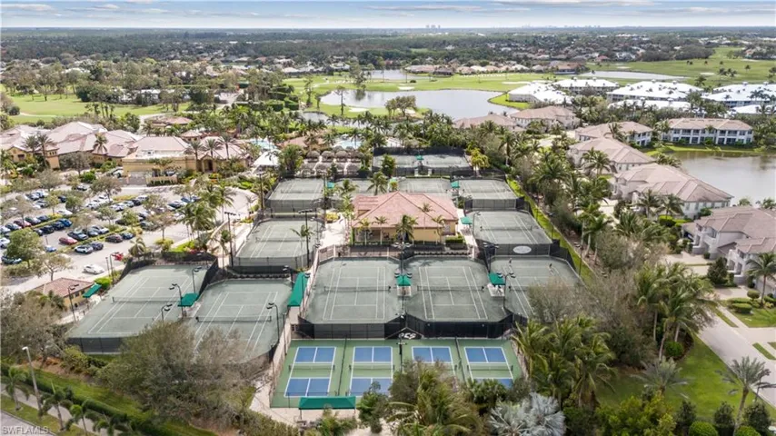 Aerial view of property's location with nearby suburban area, a nearby body of water, and a local golf course