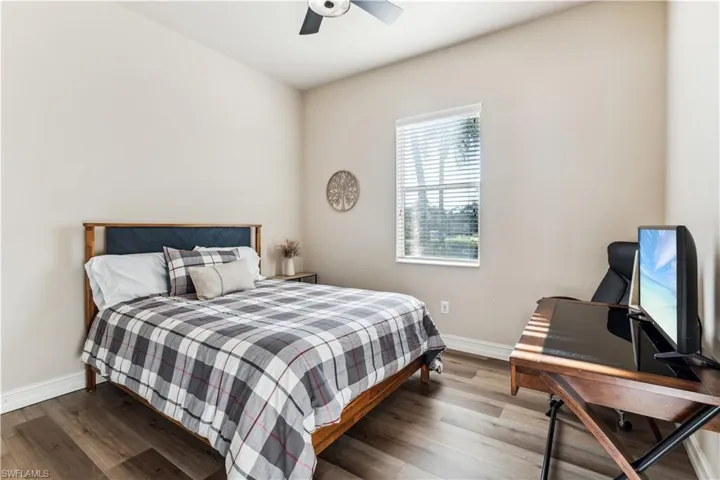 Bedroom featuring wood finished floors and a ceiling fan