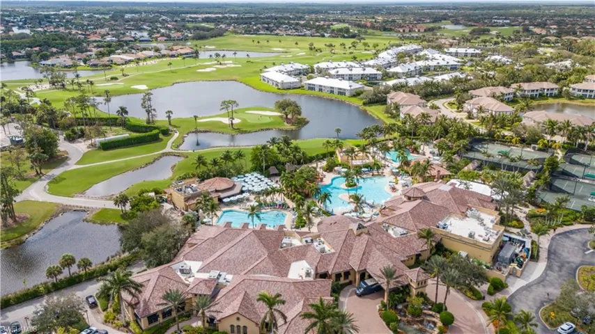 Aerial view of property's location with a large body of water and a golf club