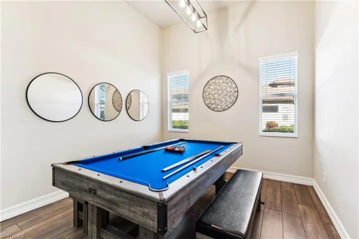 Recreation room with pool table and dark wood finished floors