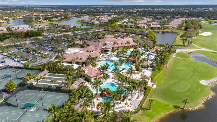 Aerial view of property and surrounding area featuring a nearby body of water and nearby suburban area