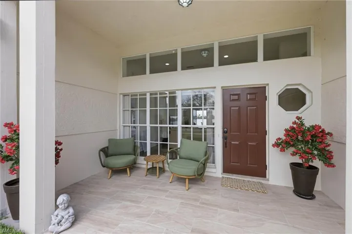 View of exterior entry featuring a patio area and stucco siding