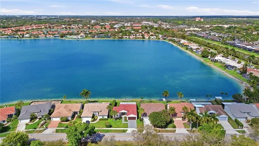 Aerial perspective of suburban area featuring a nearby body of water