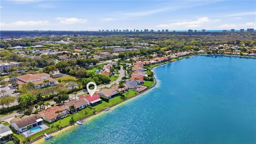 Aerial view of residential area with city skyline and a large body of water