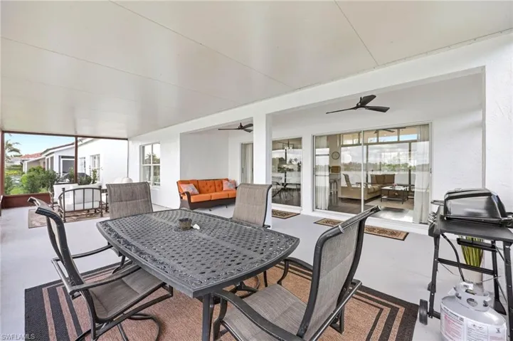 Sunroom with ceiling fan, an outdoor living / dining area, and healthy amount of natural light
