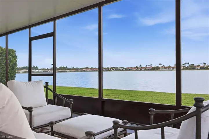 Sunroom featuring a water view