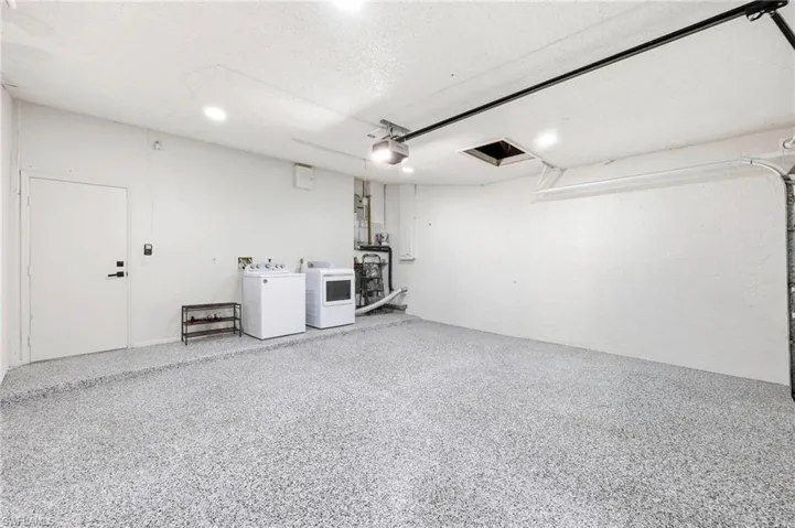Garage with washer and dryer and a garage door opener