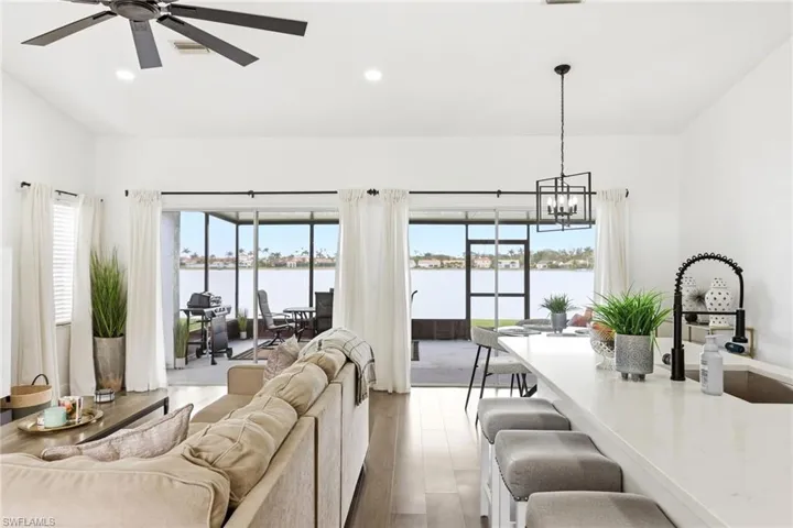 Living room featuring wood finished floors, healthy amount of natural light, and a water view