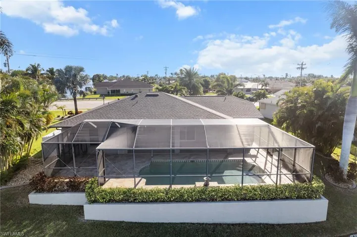 Rear view of house with a patio area and a lanai