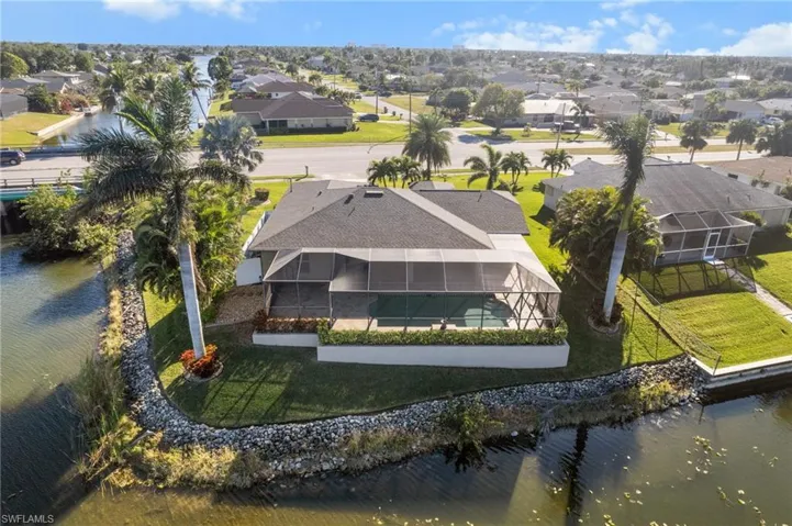 Birds eye view of property with a water view