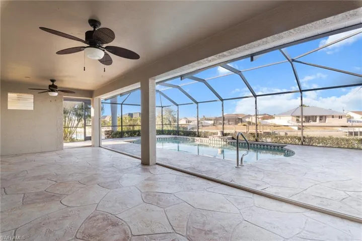 View of patio featuring ceiling fan and glass enclosure