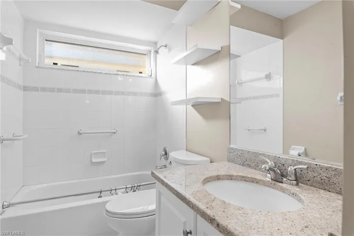 Full bathroom featuring vanity, toilet, and tiled shower / bath