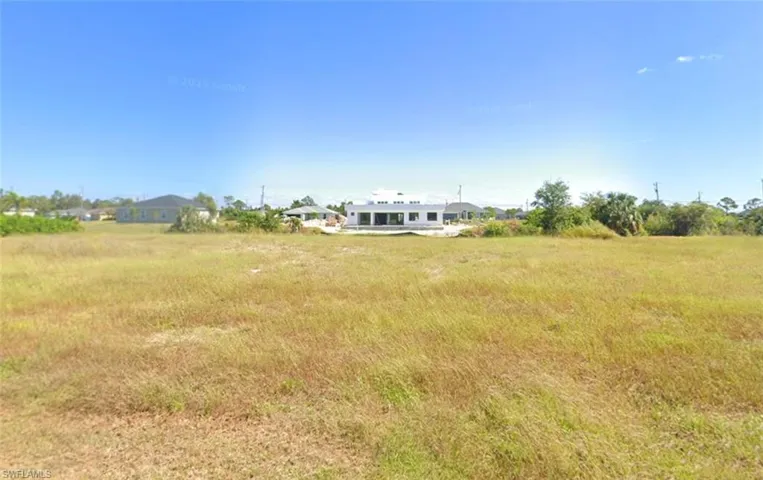 Expansive, undeveloped lot with sea wall.