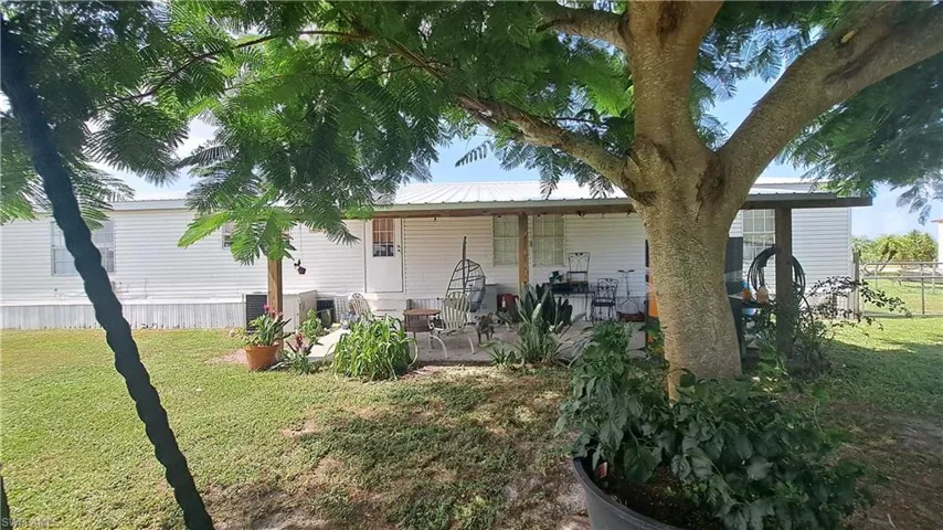 Rear view of house with a patio and a metal roof