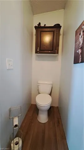 Bathroom featuring wood finished floors and a textured ceiling