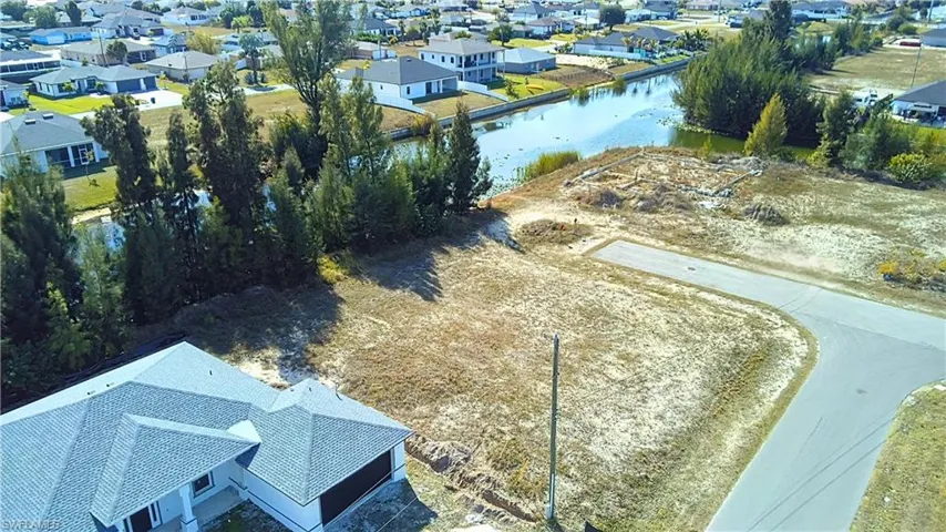 Aerial perspective of suburban area featuring a nearby body of water