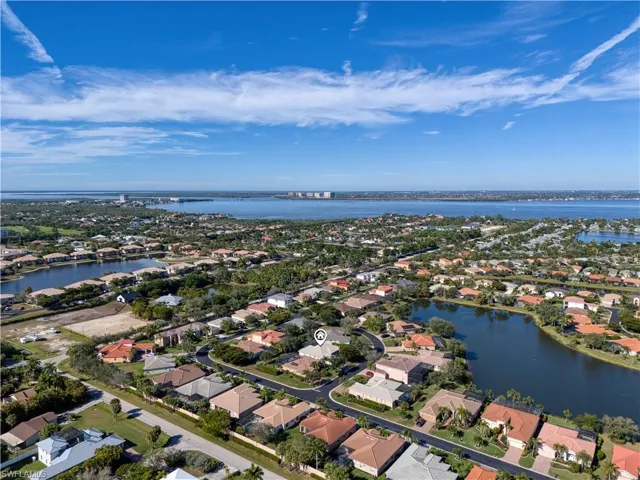 Aerial overview of property's location with a large body of water and nearby suburban area