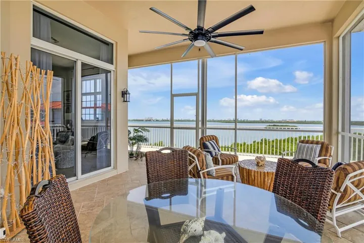 Sunroom featuring a water view and ceiling fan
