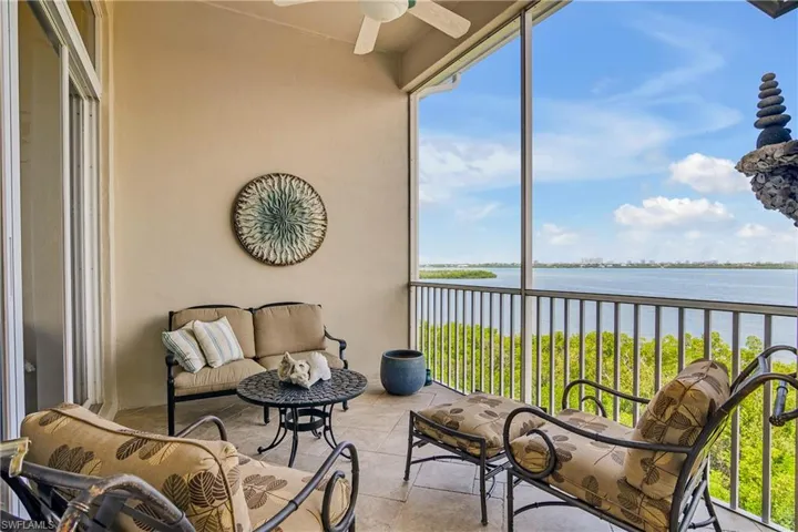 Sunroom with a water view, ceiling fan, and plenty of natural light